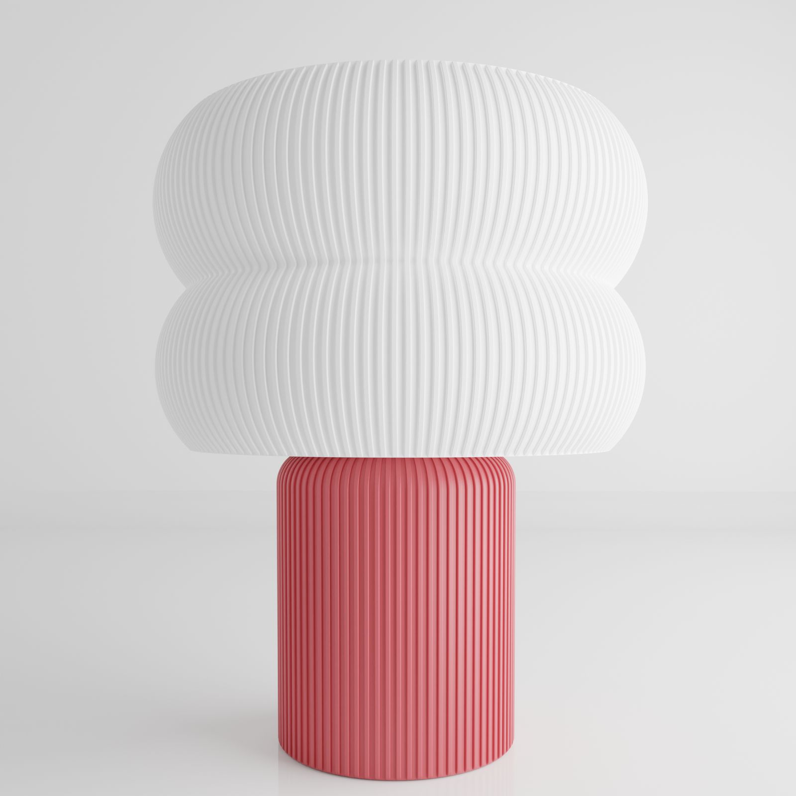 a pink and white vase sitting on top of a white table