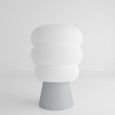 a white vase sitting on top of a table