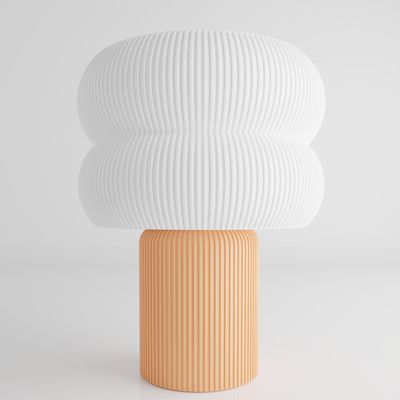 a white and orange vase sitting on top of a table