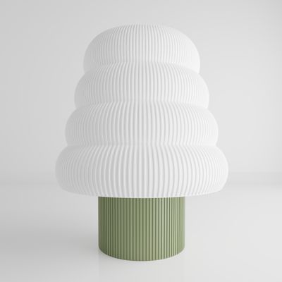 a white and green vase sitting on top of a table