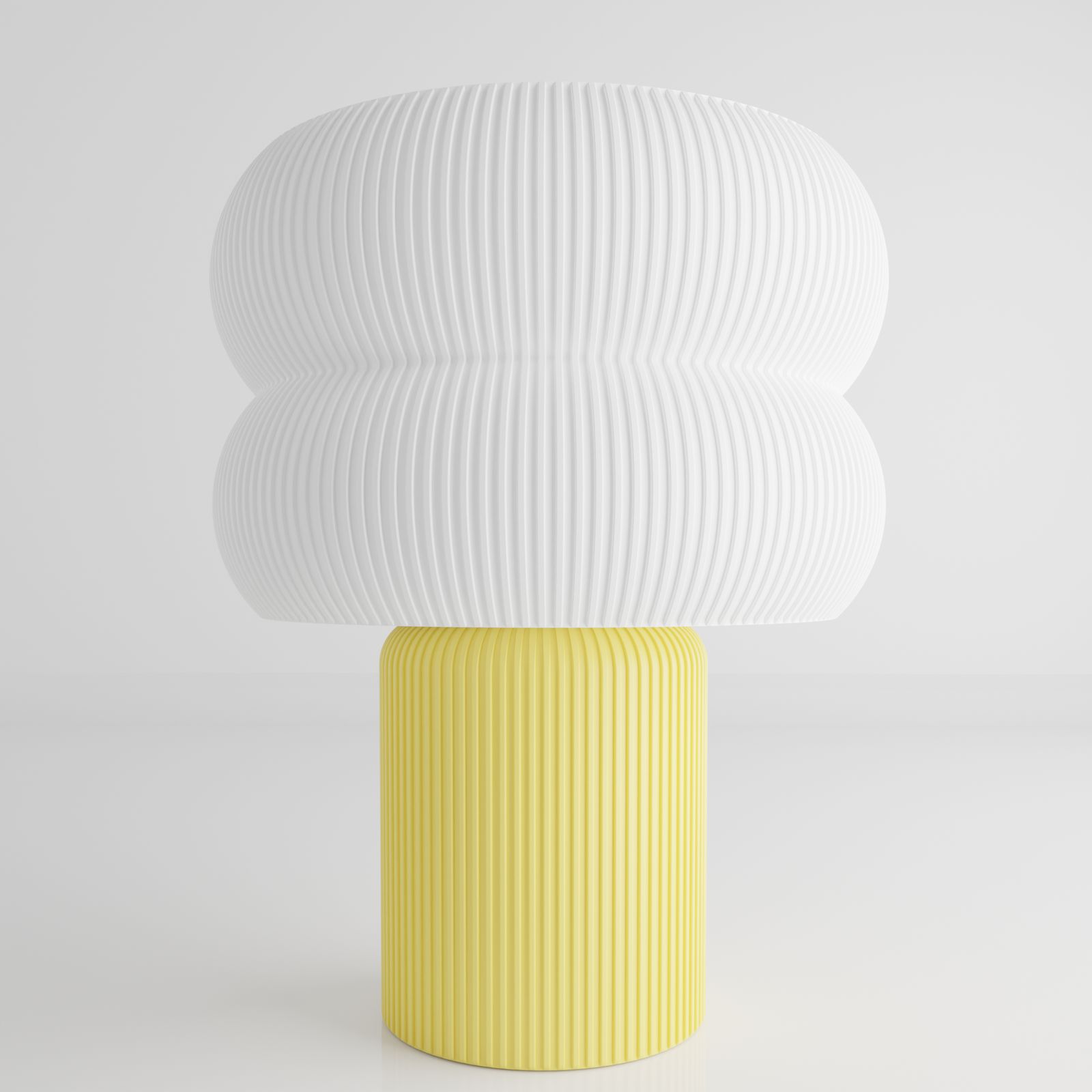 a yellow and white vase sitting on top of a table