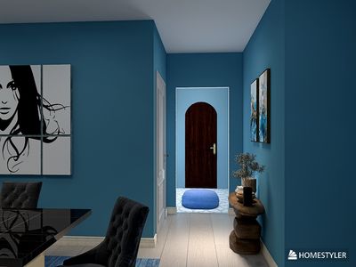 a room with a blue wall and a painting on the wall