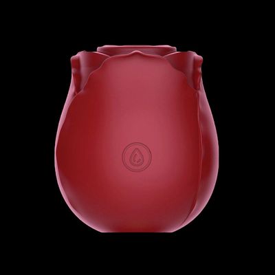 a red vase sitting on top of a black table
