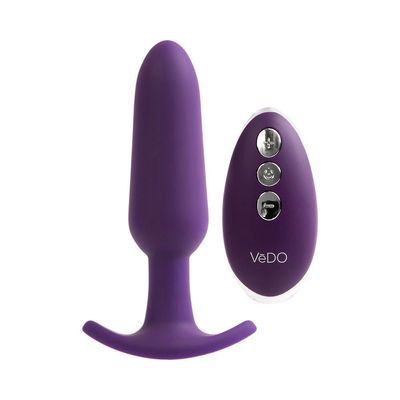 a purple vibrating device sitting next to a white background