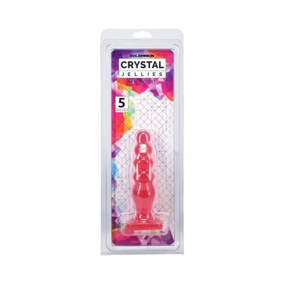 a red plastic figure in a plastic package