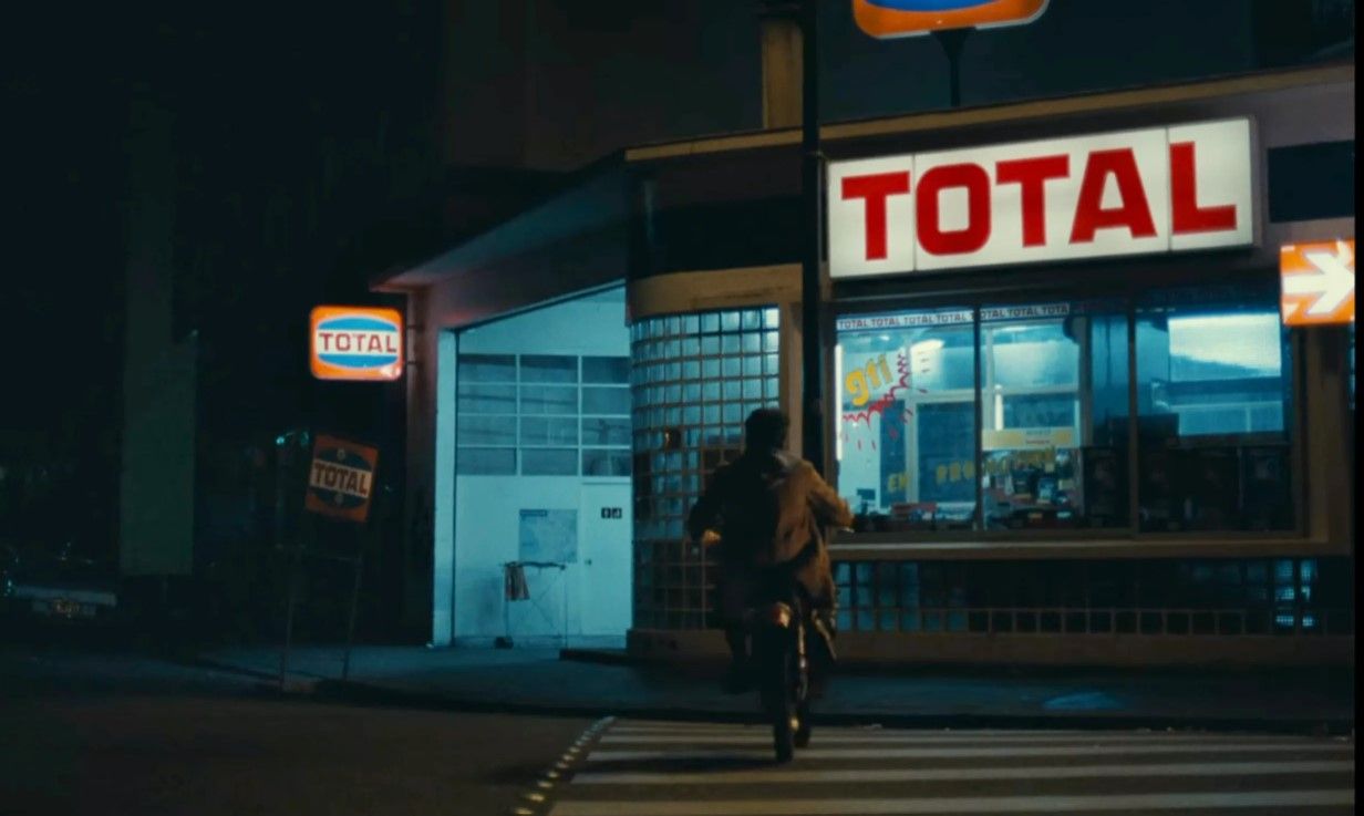 a person riding a bike down a street at night