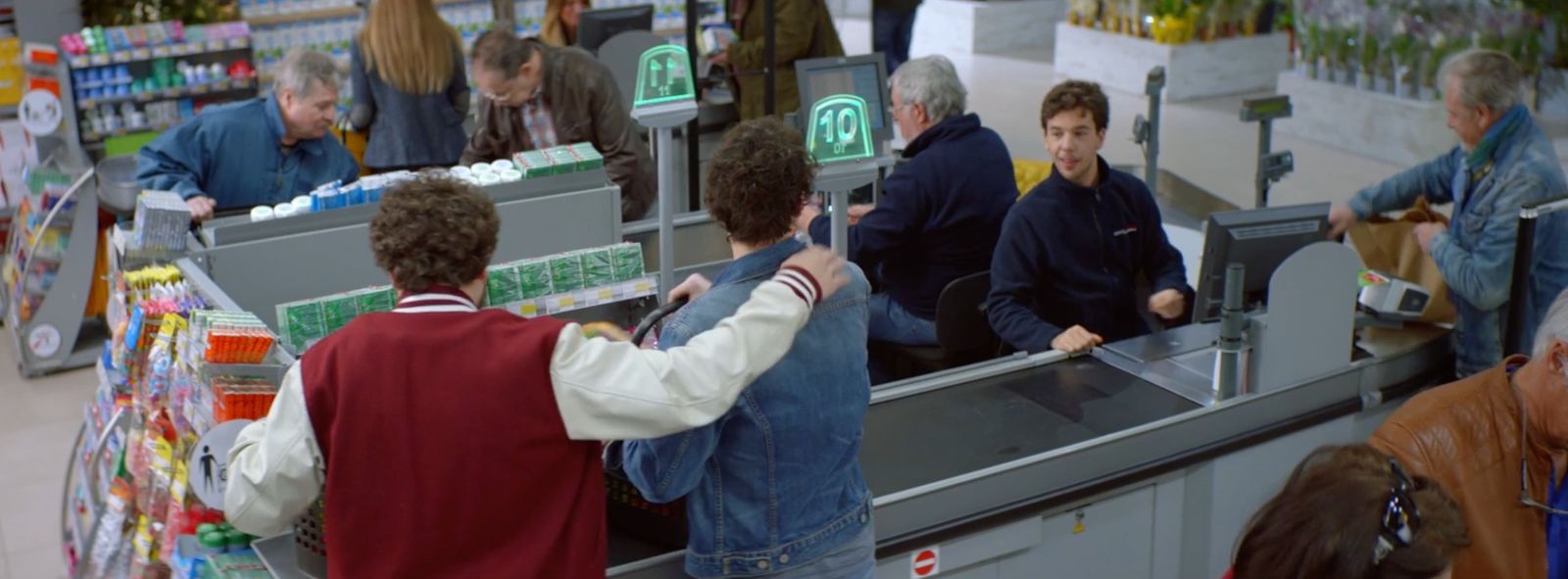 a group of people standing around a cash register