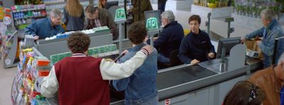 a group of people standing around a cash register