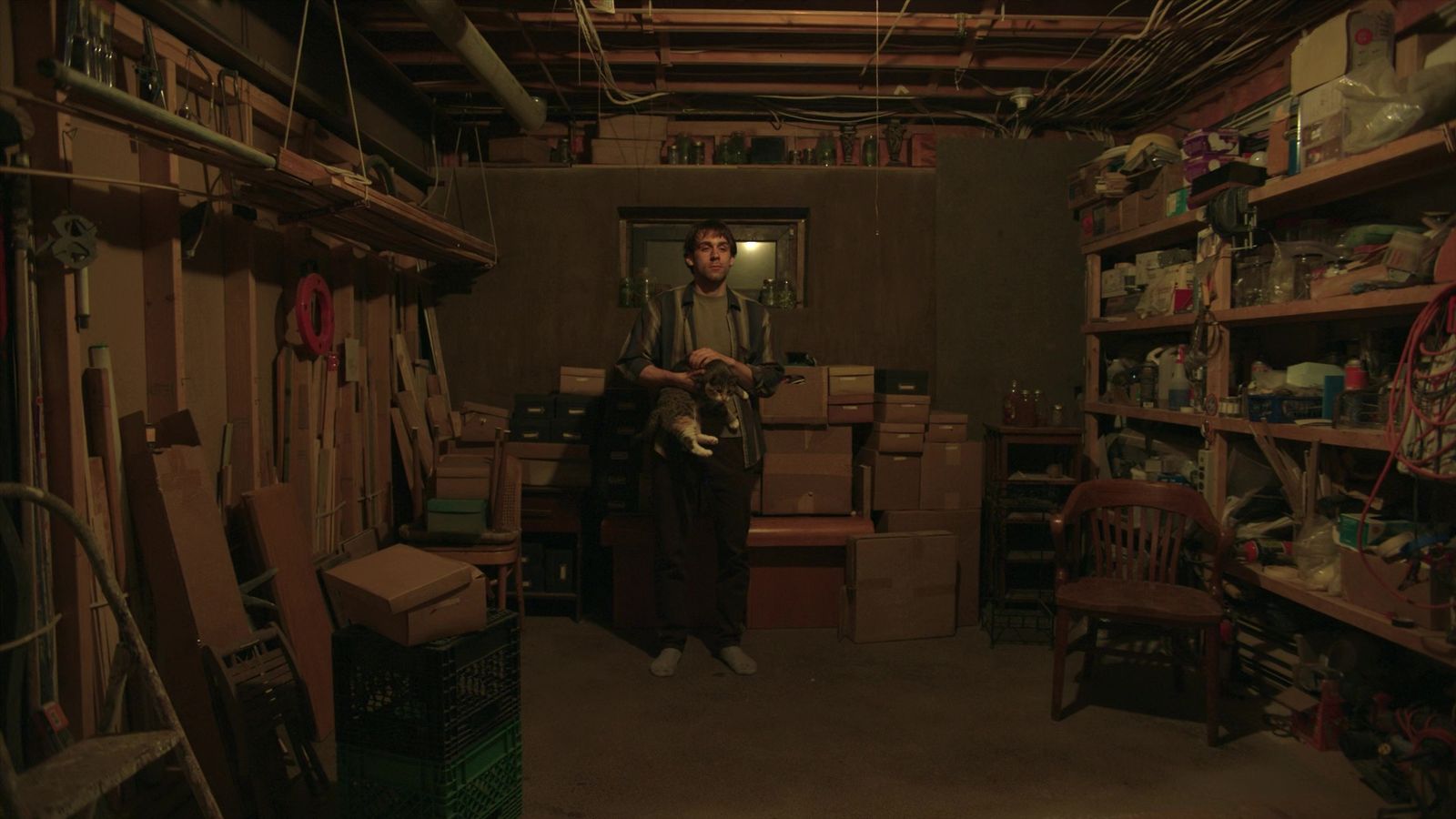 a man standing in a room filled with boxes