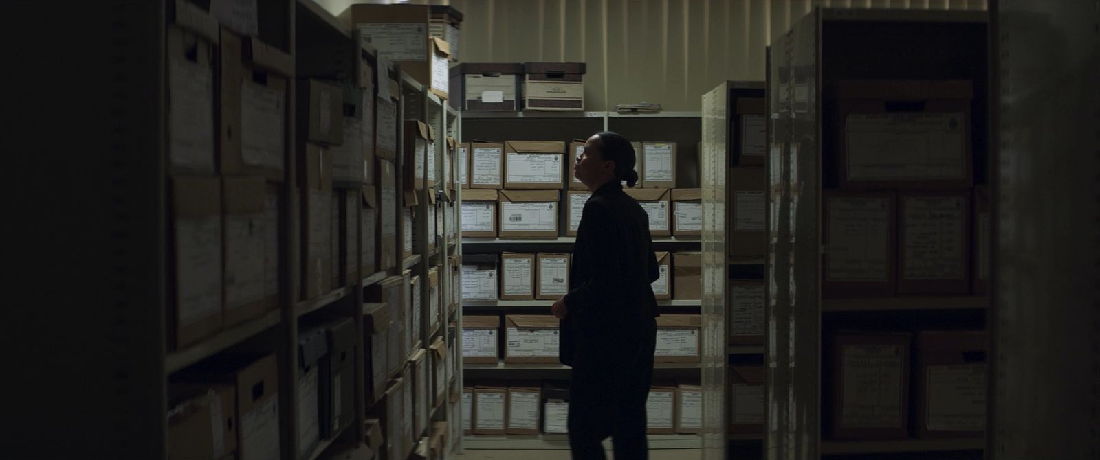 a person standing in a room with stacks of boxes