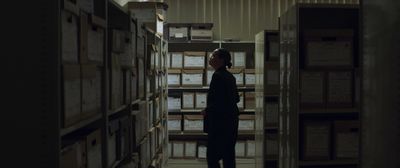 a person standing in a room with stacks of boxes