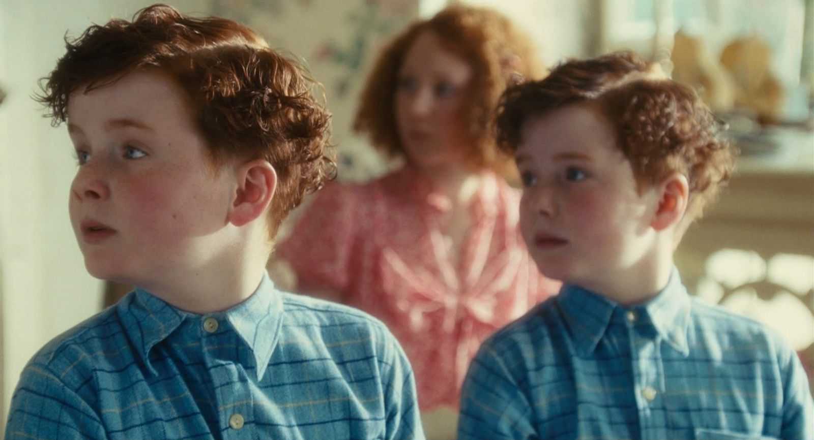 a young boy looking at himself in the mirror