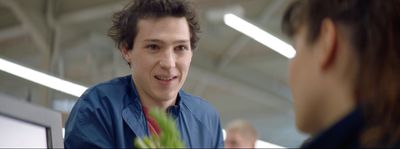 a man talking to a woman in a blue shirt