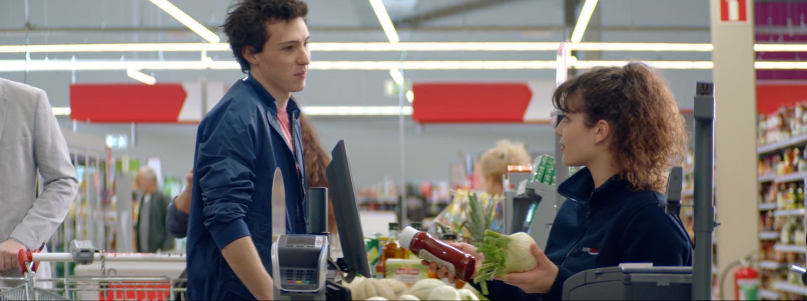 a couple of men standing next to each other in a store