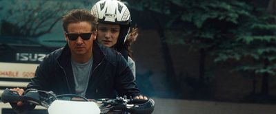 a man riding a motorcycle next to a woman