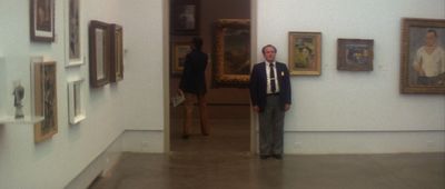 a man in a suit and tie standing in a hallway