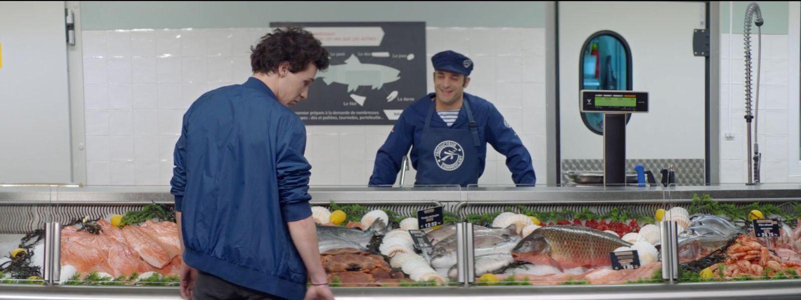 a man standing in front of a fish display