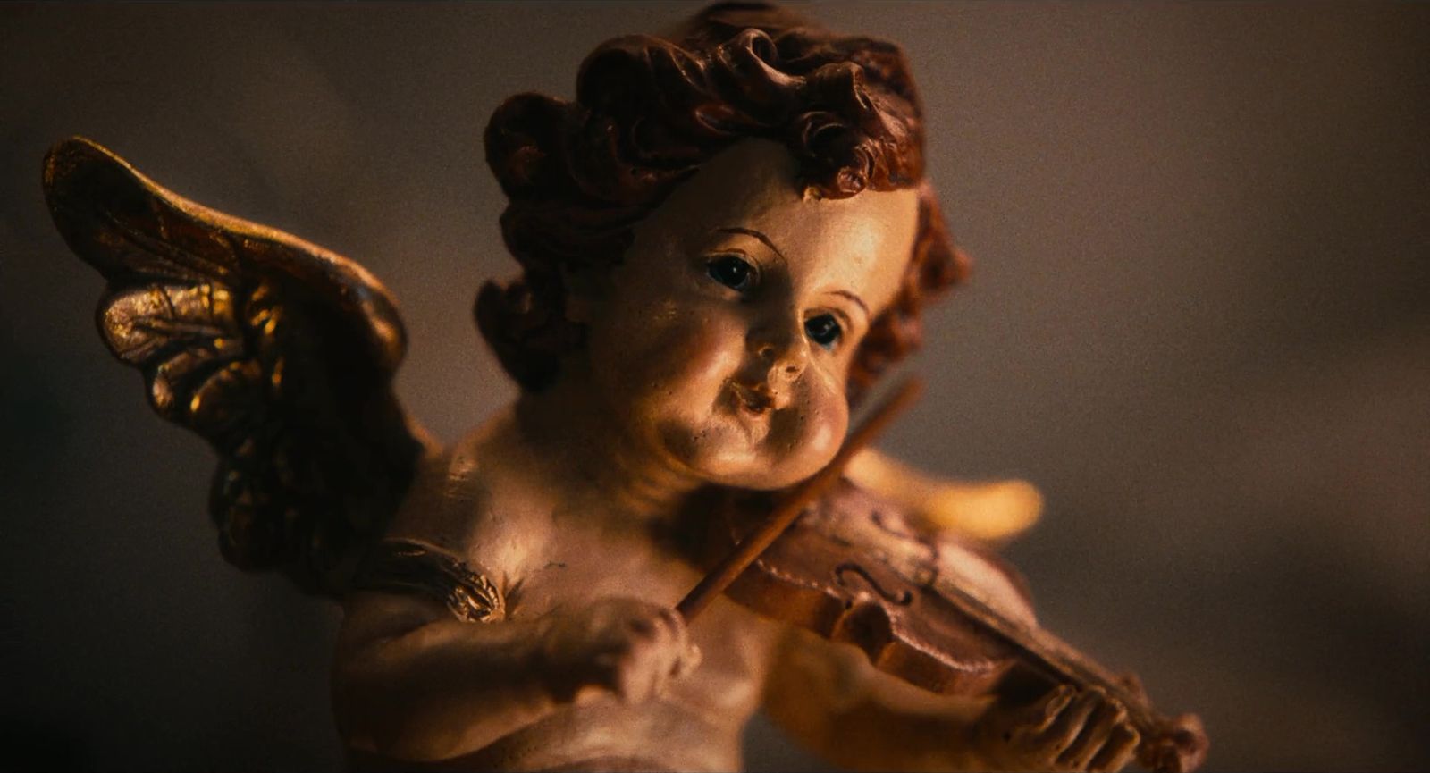 a statue of an angel holding a violin