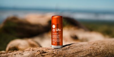 a can of deodorant sitting on top of a log