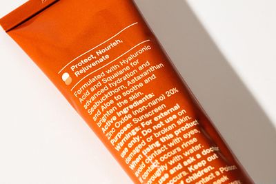 a tube of sunscreen on a white surface