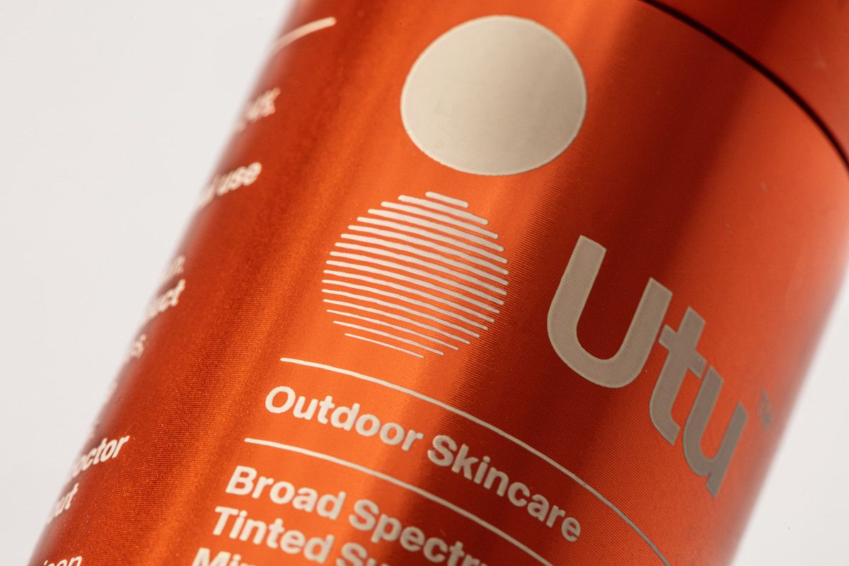 a close up of a red bottle of hair product