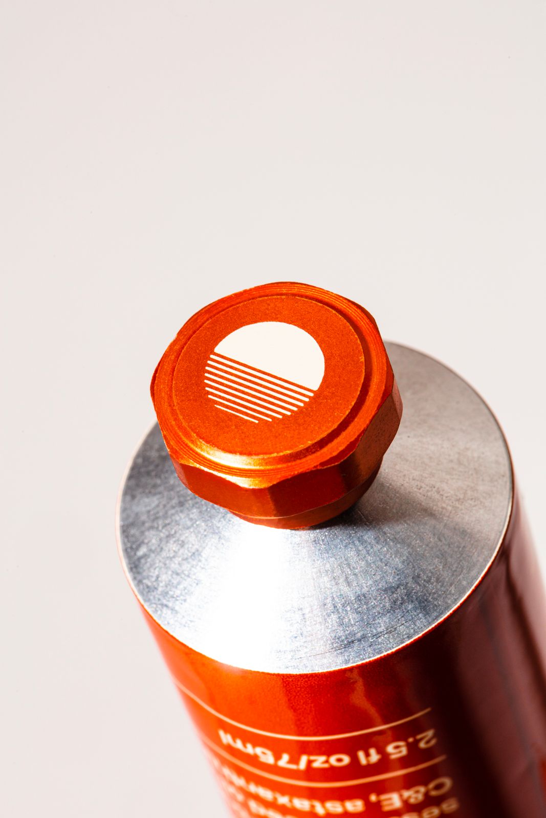a close up of a red can on a white surface