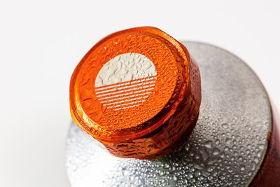 a close up of an orange object on a white surface