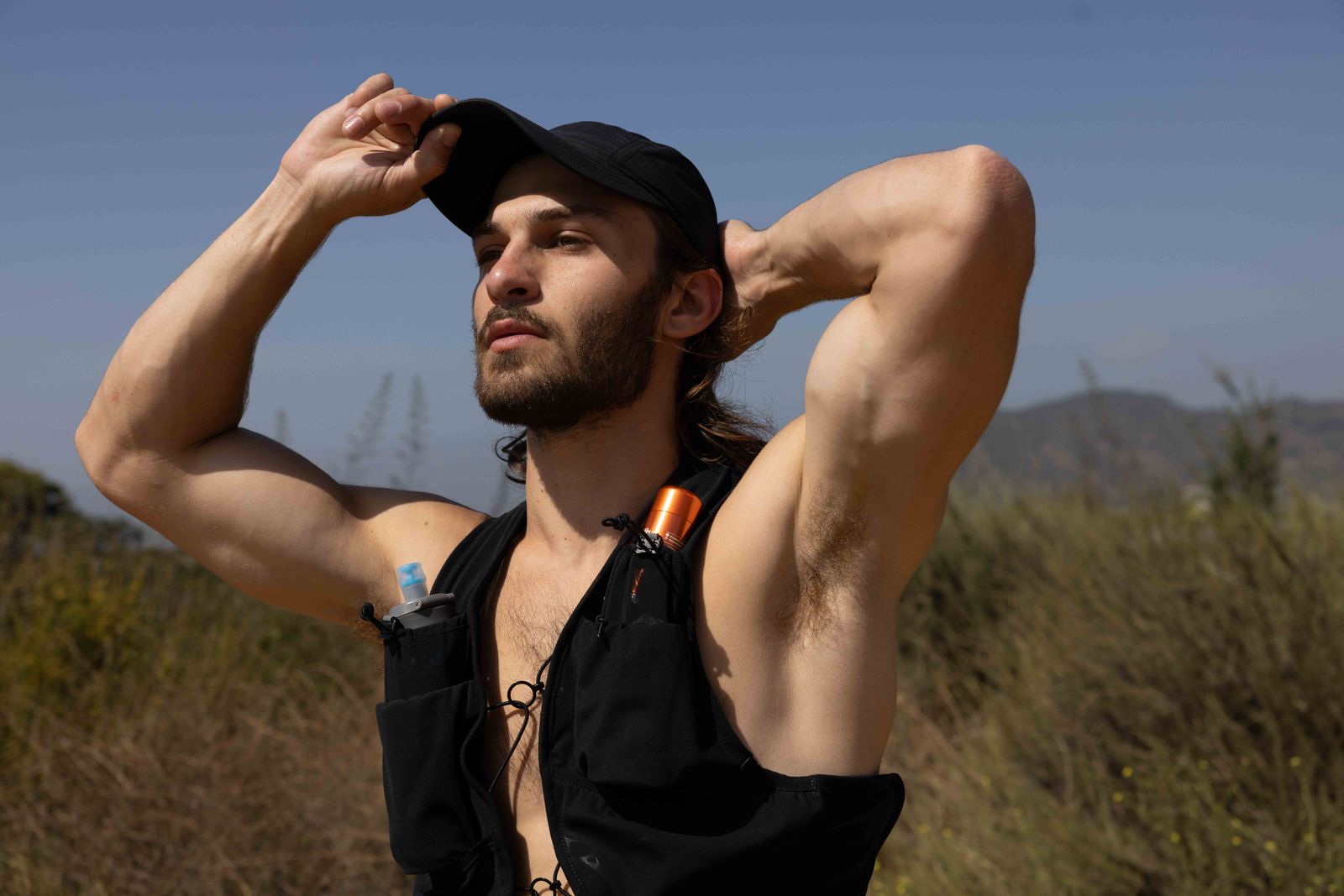 a man in a black shirt and a black hat