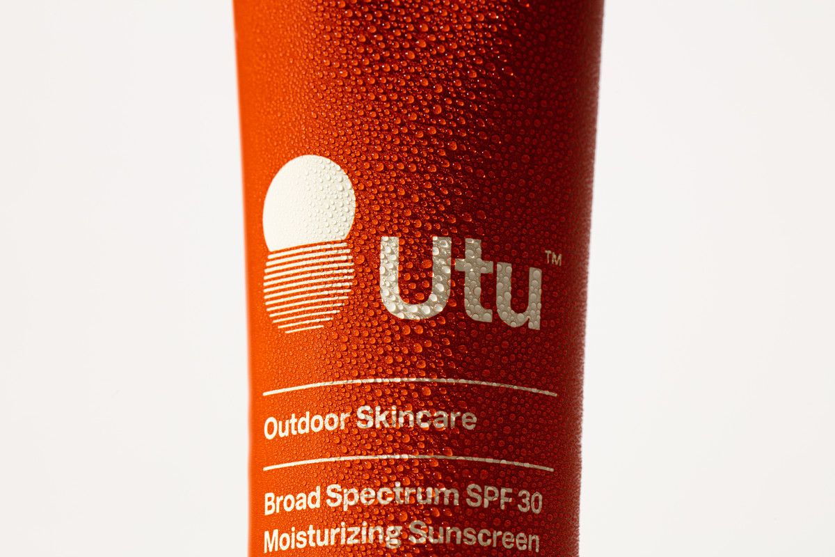 a close up of a tube of sunscreen on a white background