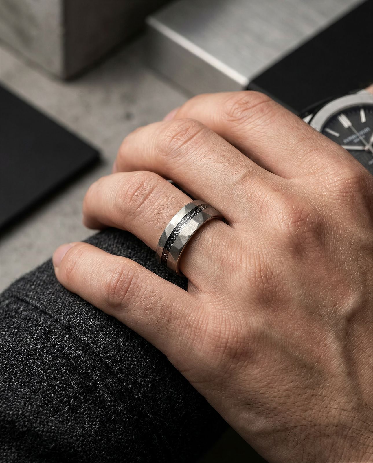 a man wearing a wedding band and a watch