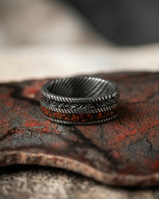 a close up of a ring on a piece of wood