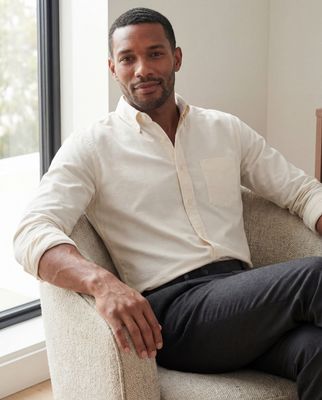 a man sitting in a chair in front of a window