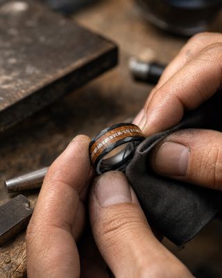 a man is working on a wooden ring