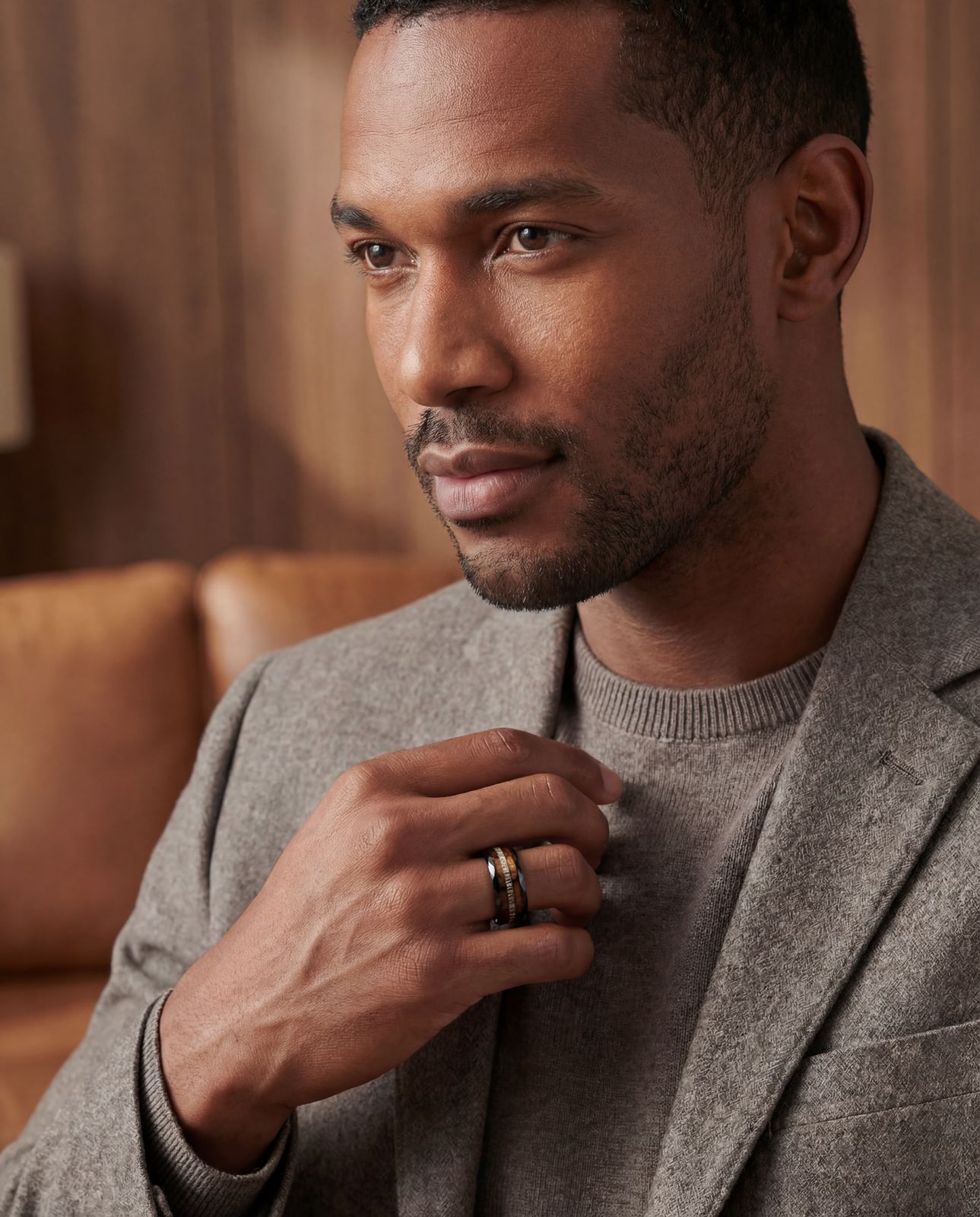 a man in a gray suit and a gold ring