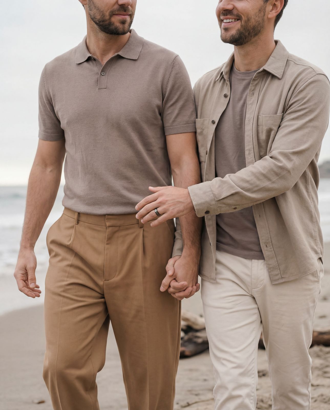 a couple of men standing next to each other on a beach