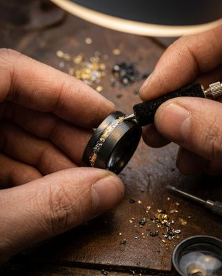 a man is working on a ring in his workshop