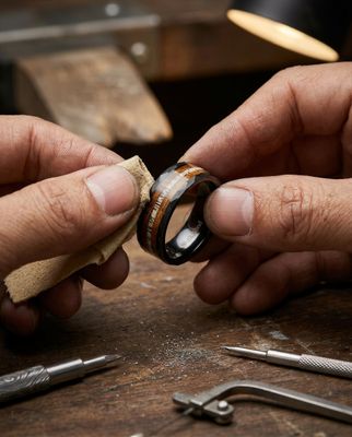 a man is working on a ring in his workshop