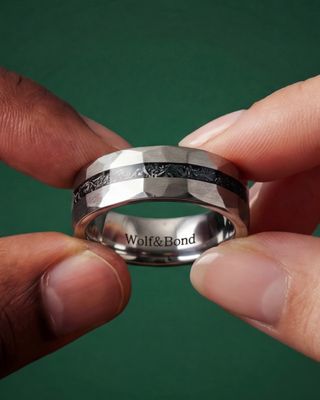 a person holding a ring in their hand