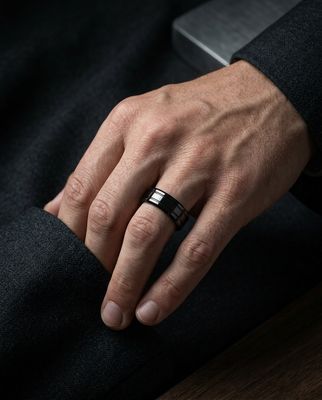 a man's hand with a ring on it