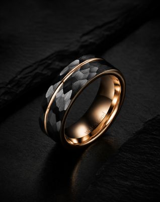 a black and gold ring with a flower pattern