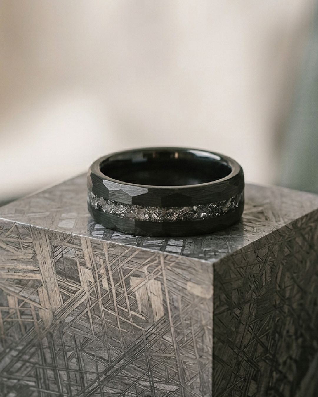 a black ring sitting on top of a wooden block