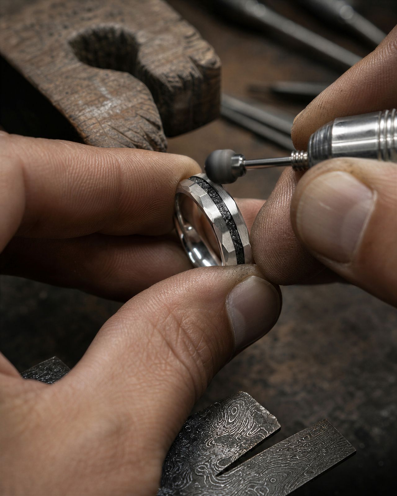 a man is working on a ring in his workshop