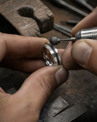 a man is working on a ring in his workshop