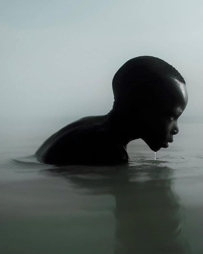 a man in the water with his head in the water