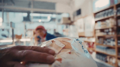 a person holding a bag of food in a store