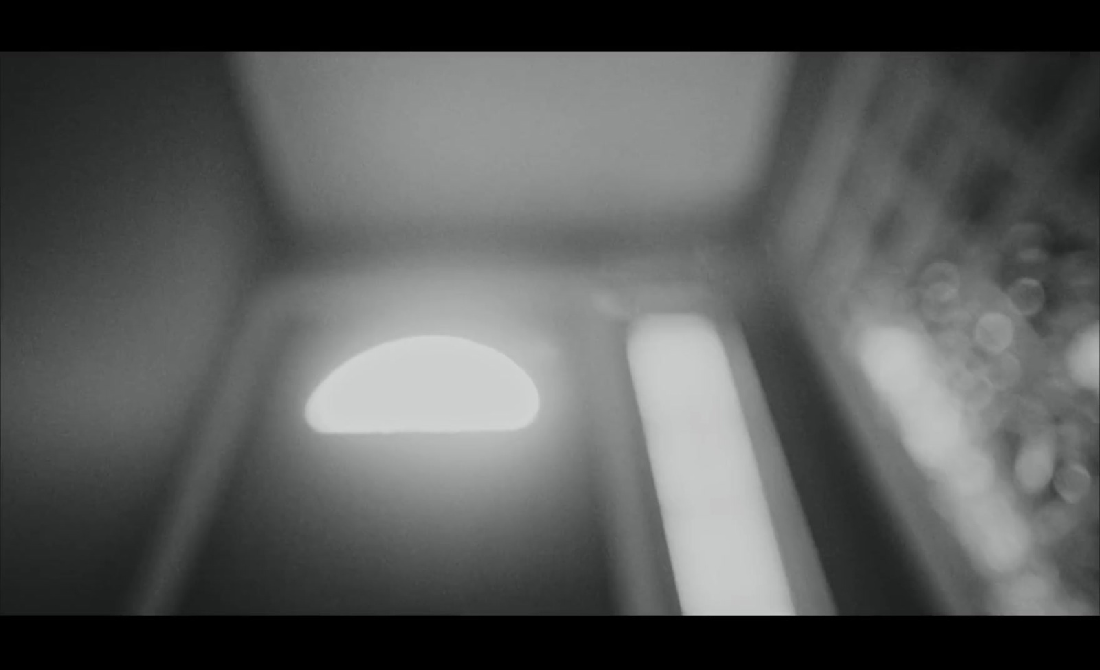 a black and white photo of a light in a room