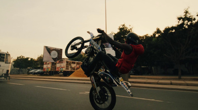 a person on a motorcycle doing a trick in the air