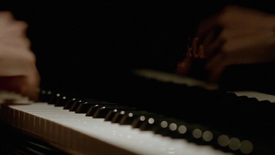 a close up of a person playing a piano