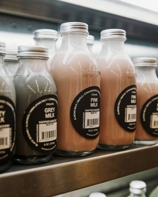 a row of bottles of milk on a shelf