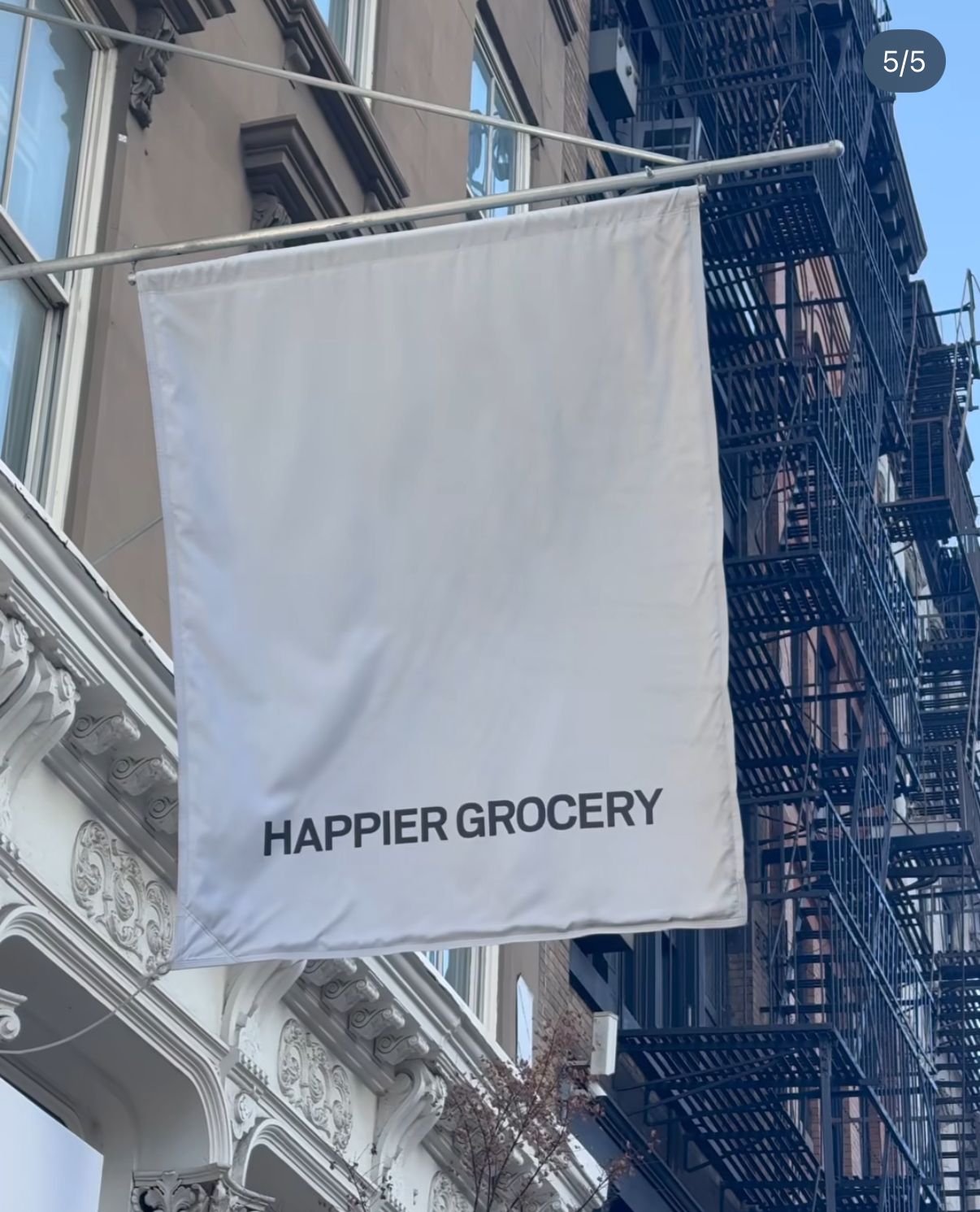 a large white banner hanging from the side of a building